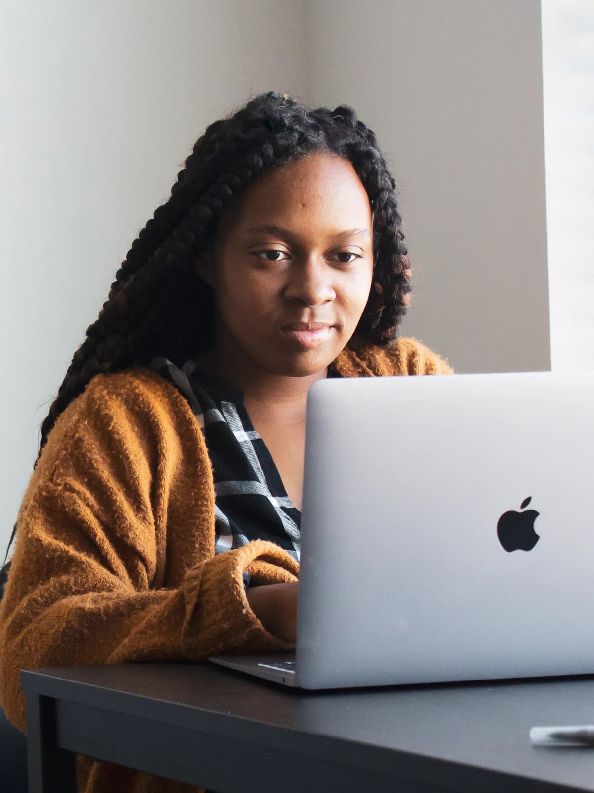 A student working on her project at a laptop