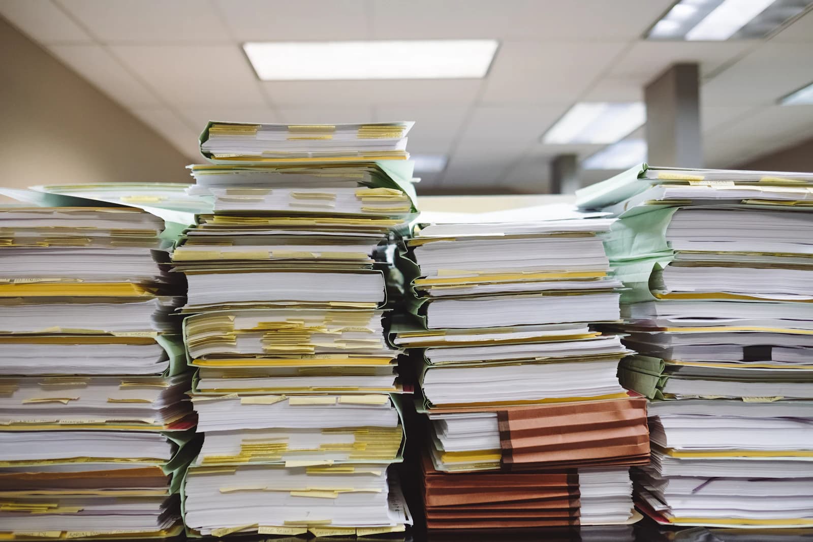 Stacks of printed documents on a desk