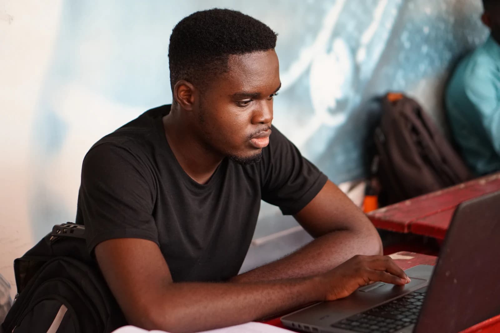 A student working on his project at a laptop